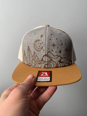 Crescent Moon over mountains trucker hat